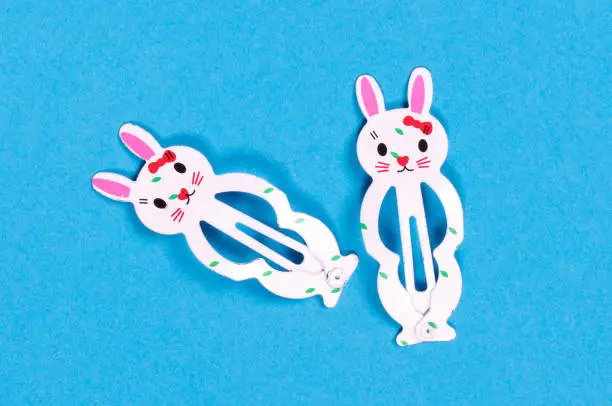 Bunny hairclips for girl, isolated on a blue background