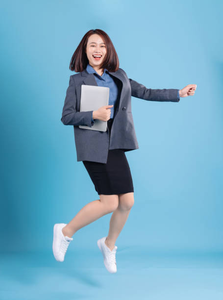 istock Asian businesswoman on blue background 1473646769