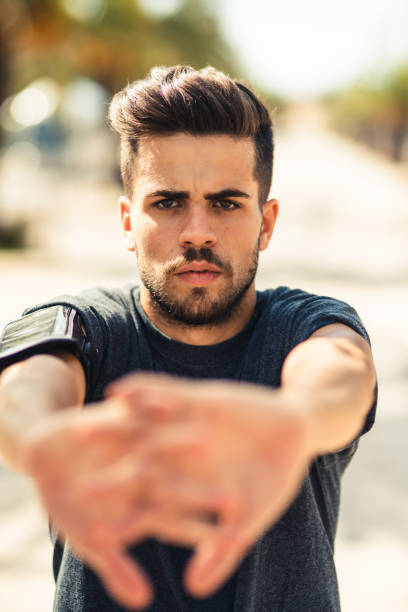 man stretching his arm outdoor