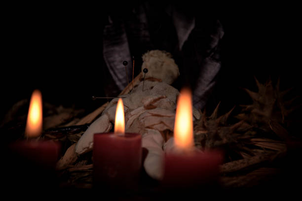 istock Voodoo Doll on a wooden background with dramatic lighting. 1473650798