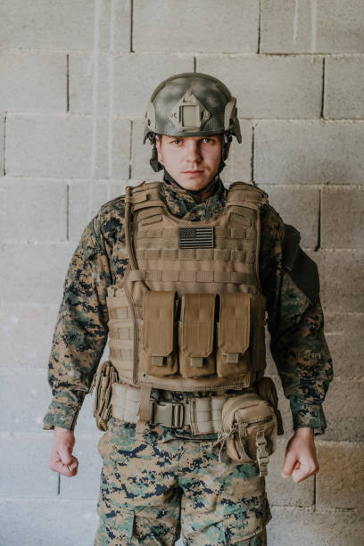istock Soldier preparing tactical protective and communication gear for action battle 1473652249