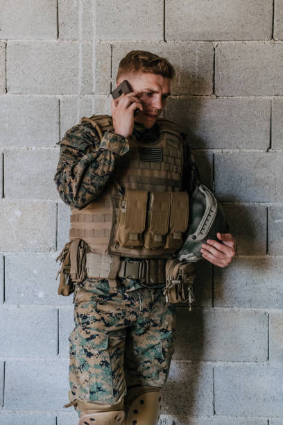 istock Soldier using smartphone and calling home family and friends 1473652641
