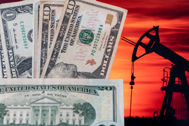 istock Us dollars on a oil mining background. Petrol dollar concept. 1473652940