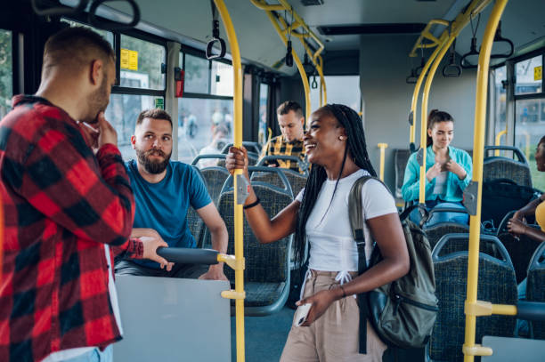 istock Multiracial friends talking while riding a bus in the city 1473654147