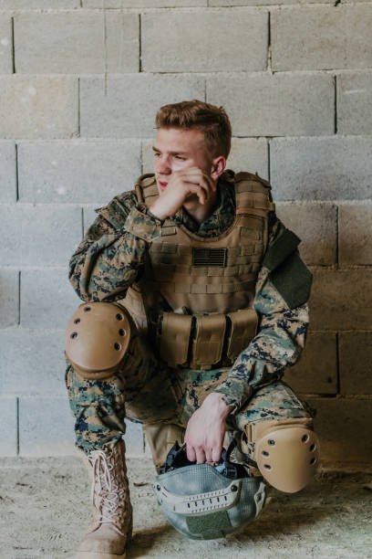 istock Upset soldier has psychological problems holding his head 1473656086