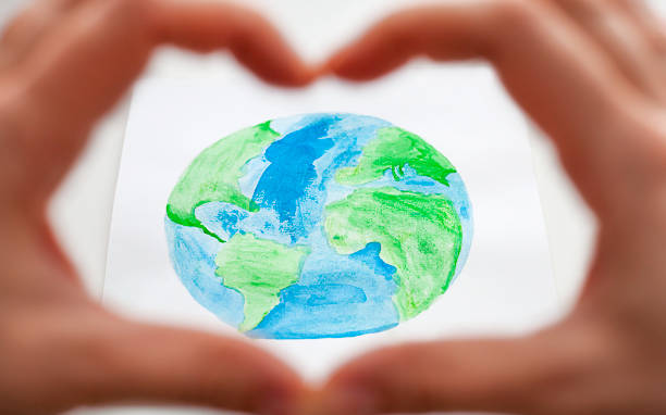 istock Hands forming a heart with the earth in the middle 1473659035