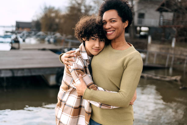 istock Mother and son bonding and hugging by the river 1473659239