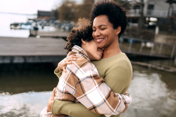 istock Mother and son bonding and hugging by the river 1473659278