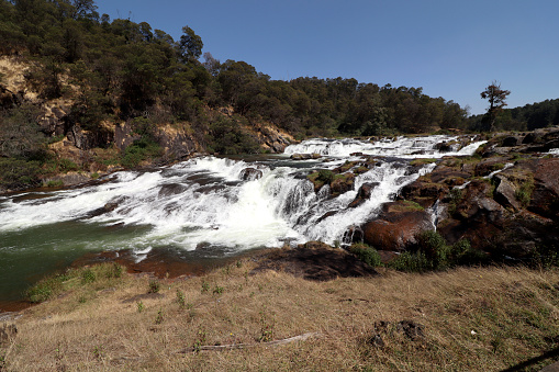 Scenic view of Pykara waterfalls Tamil Nadu during springtime under the beautiful clear sky during summer season.