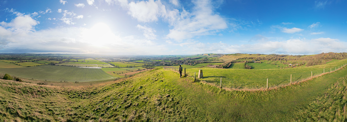 backpacker walking on footpath, beautiful hill and landscape near Pewsey, South of England, United Kingdom, winter daytime