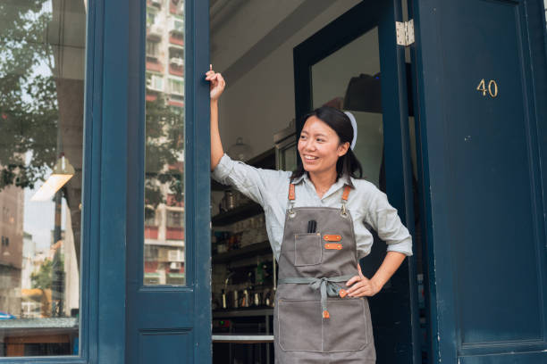 Coffee shop owner with Open sign