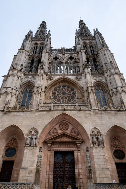 istock Burgos Cathedral main entrance with the display cases and columns overhead under a cloudy sky on a cold spring day. 1473662447