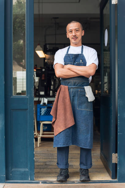 istock Coffee shop owner with Open sign 1473663004