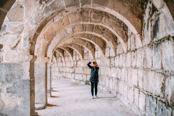 istock Young Woman Exploring Ancient Amphitheater 1473663006