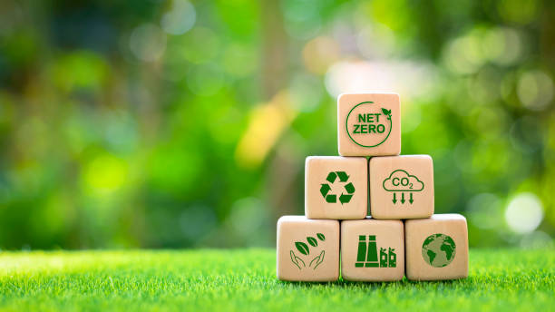 istock Net Zero or reducing net greenhouse gas emissions to zero. low carbon emission concept Climate neutral strategy limits global warming, green icon on wooden block 1473663341