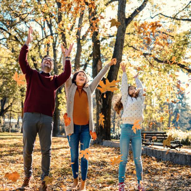 istock Family throwing leaves 1473663730