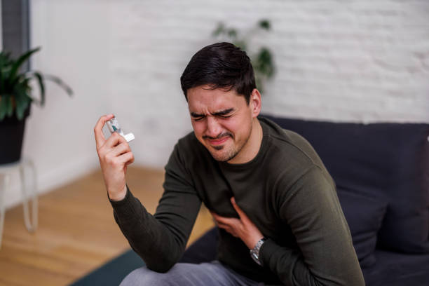 istock A young asthmatic man is suffering from chronic allergy and using an asthma inhaler. 1473664447