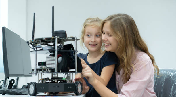 istock Children using the hand robot technology and having fun Learning the electronic circuit board of hand robot technology, which is one of the STEM courses. 1473664481