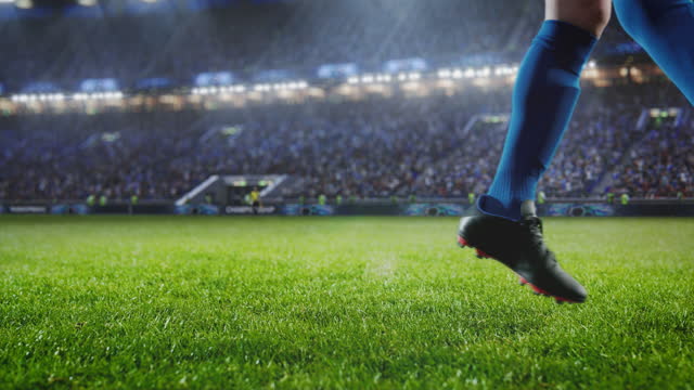 Aesthetic Shot Of Athletic Caucasian Footballer Shooting A Penalty Kick On Stadium With Crowd Cheering. International Soccer Championship Final Match With Fans On Tribune. Super Slow Motion.