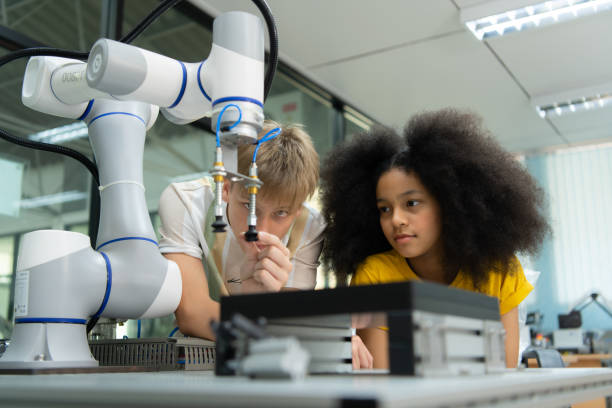 istock Children using the hand robot technology, Students are studying technology, which is one of the STEM courses. 1473664983