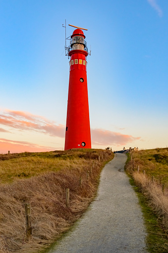 Schiermonnikoog panoramic view in the dunes with the lighthouse during sunset at the wadden island during a beautiful winter day. Schiermonnikoog is part of the Frisian Wadden Islands and is known for its beautiful natural scenery, including sandy beaches, rolling dunes, and lush wetlands.