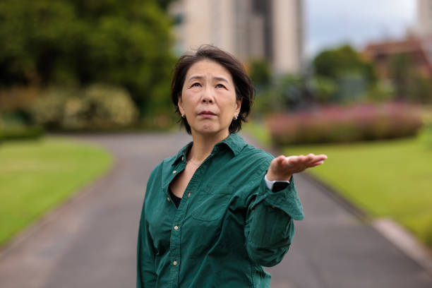 istock Woman looking up and checking for rain 1473665495