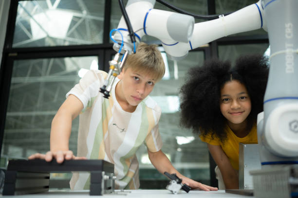 istock Children using the hand robot technology, Students are studying technology, which is one of the STEM courses. 1473665574