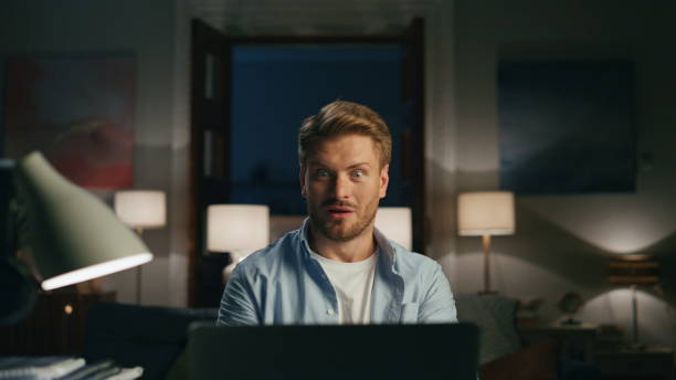 istock Confused man videocalling apartments closeup. Surprised guy talking online 1473667419