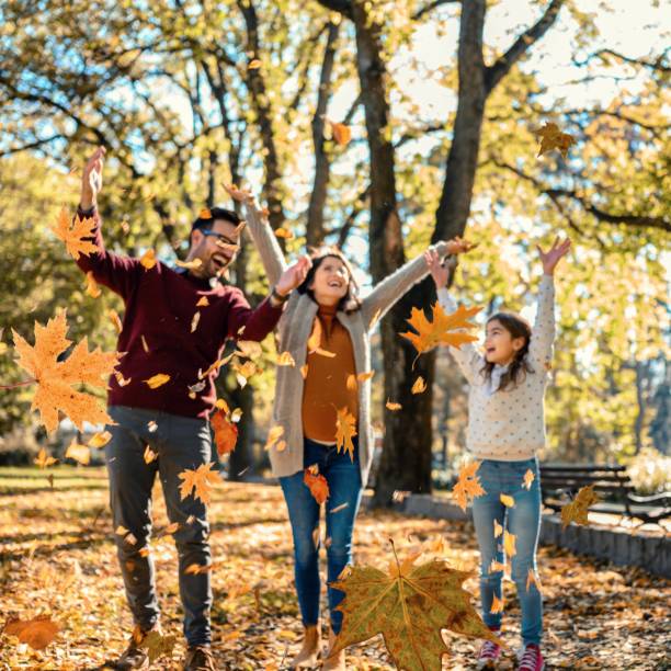 istock Family throwing leaves 1473667462