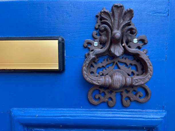 istock Vintage door knocker on a blue door 1473667520