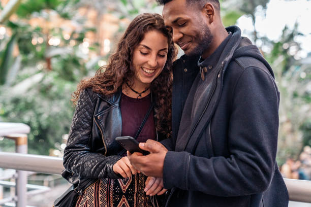 istock Happy Young Couple Using Phone 1473667918
