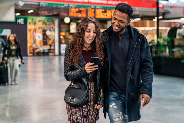 istock Happy Young Couple Using Phone 1473667919