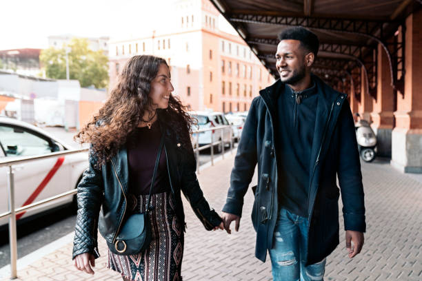 istock Interracial Young Couple Holding Hands 1473667931
