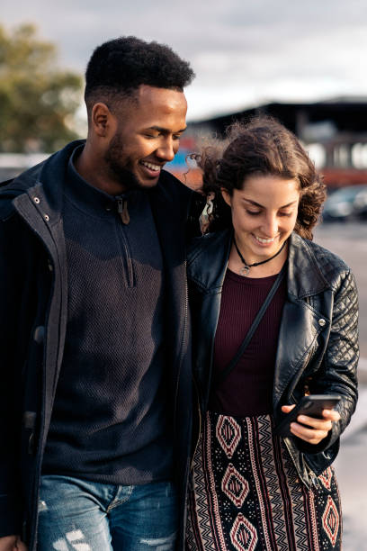 istock Happy Young Couple Using Phone 1473667948