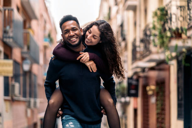 istock Happy Interracial Couple doing piggyback 1473667993