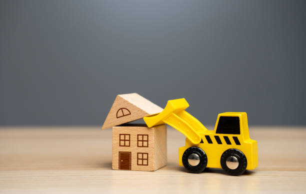 istock The bulldozer demolishes the house. 1473669713