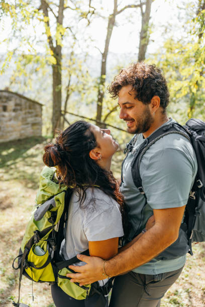 istock Lovely couple hiking in mountain. They take a romantic break 1473669900