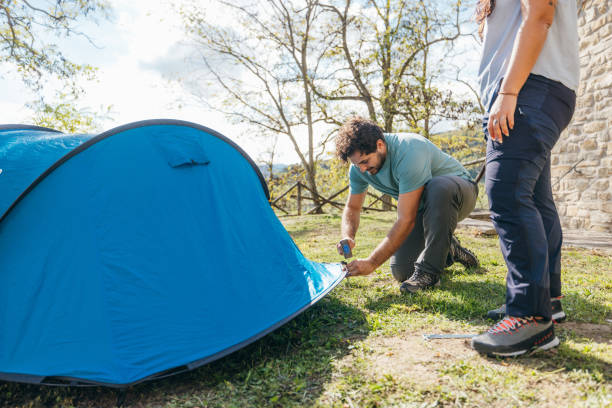 istock Couple building a tent in mountain 1473671344