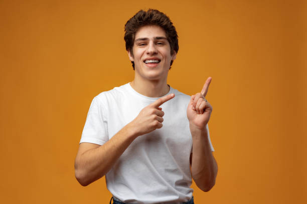 istock Young handsome man over blue background pointing to the side 1473672545
