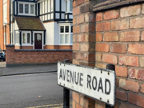 istock Street name sign near the wall 1473672783