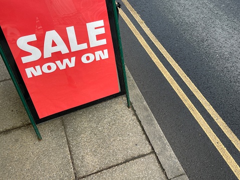 Cropped top view shot of a red sale announcement sign