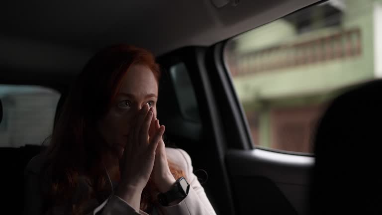 Worried mature businesswoman in a car