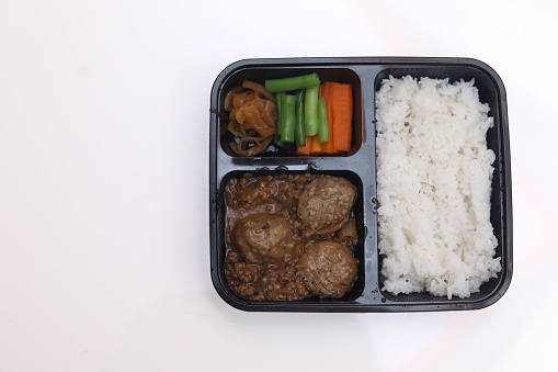 Meatball, rice and vegetable lunch menu packages in plastic boxes for take-out packages
