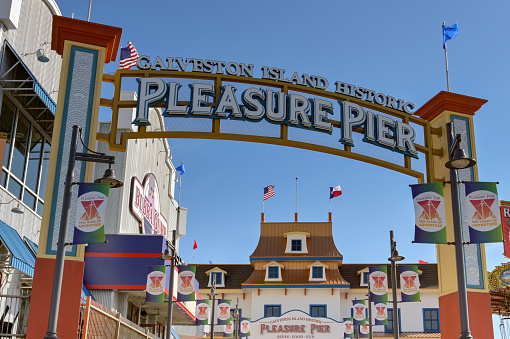 Galveston, Texas, USA - February 2023: Sign over the entrance to the historic pier on the seafront of Galveston