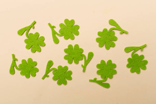istock Felt clover on color background, top view. St. Patricks day concept 1473681605