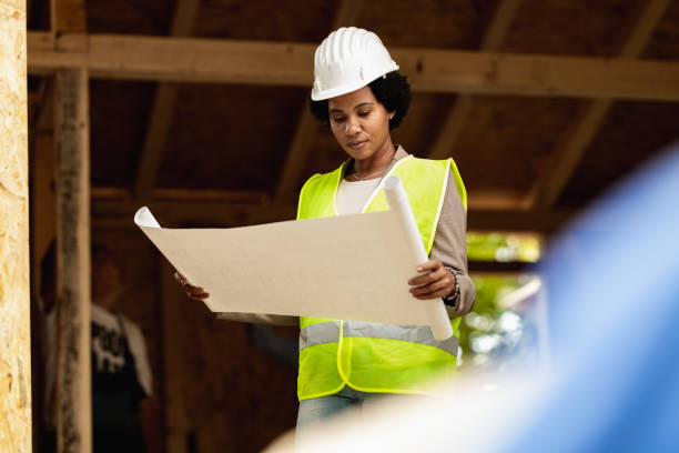 istock Black Woman Architect Checking Blueprints Project At Construction Site 1473682363