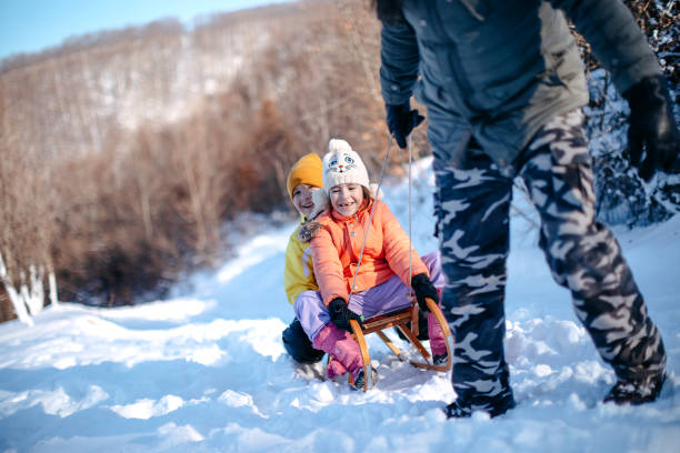 istock Family having fun on snow in the nature 1473682564