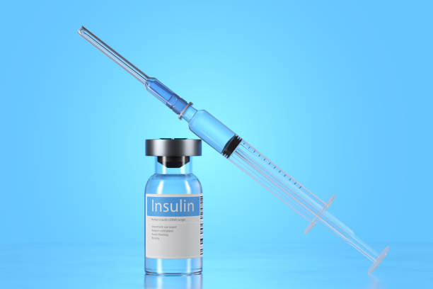istock A syringe present on the table, which may be used to extract the insulin from the vials. The vials appear to be made of glass and are labeled with the name of the insulin they contain. The syringe is transparent and appears to be empty. The metal table is 1473683386