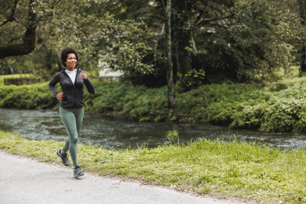 istock Black Woman Jogging In Nature 1473684270