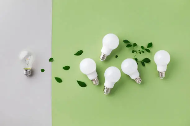 Energy efficiency concept with new generation led and simple old incandescent lightbulb top view. Power saving, eco living and sustainable lifestyle.